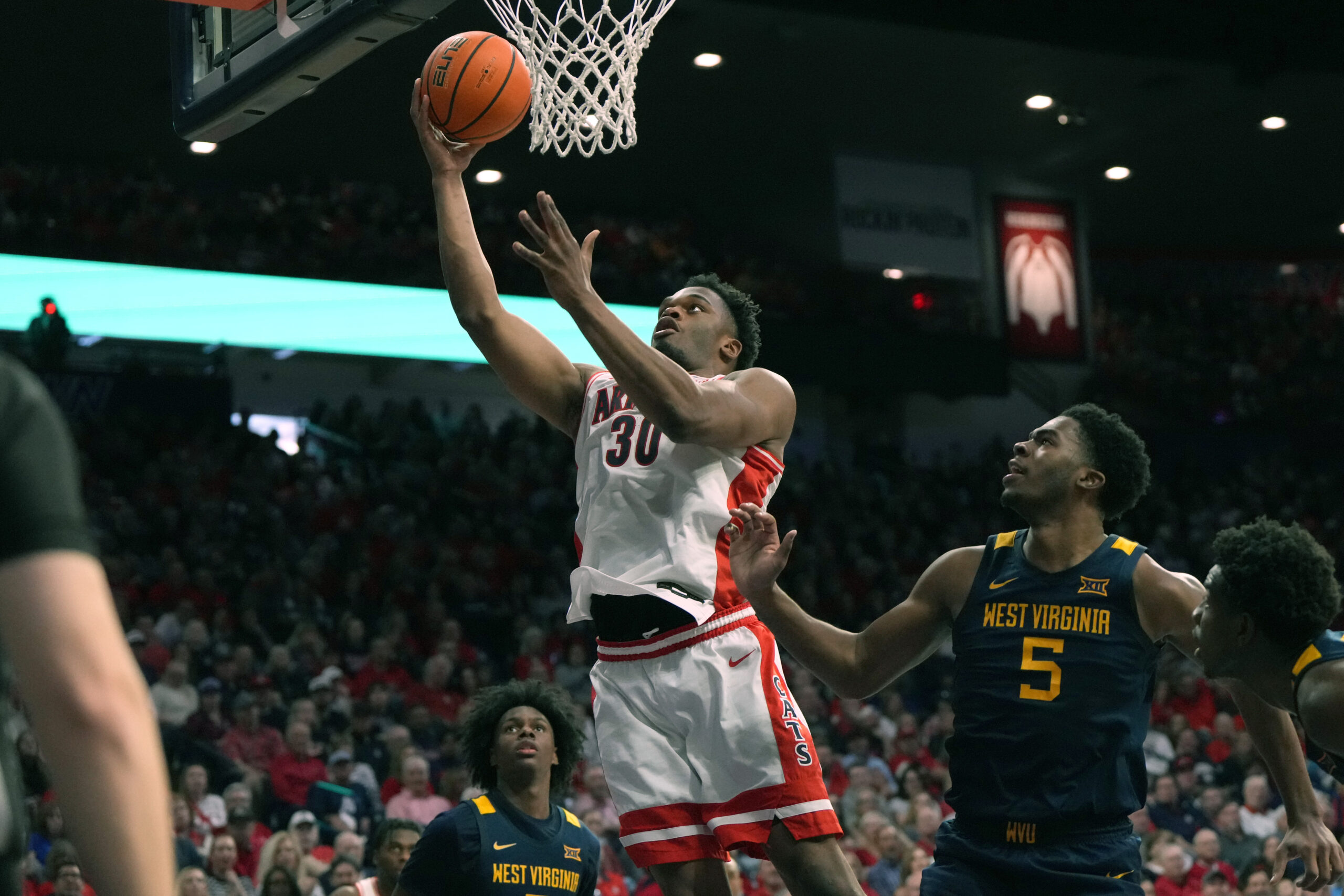 No. 1 Arizona flexes it's muscles in routing WVU men's hoops team